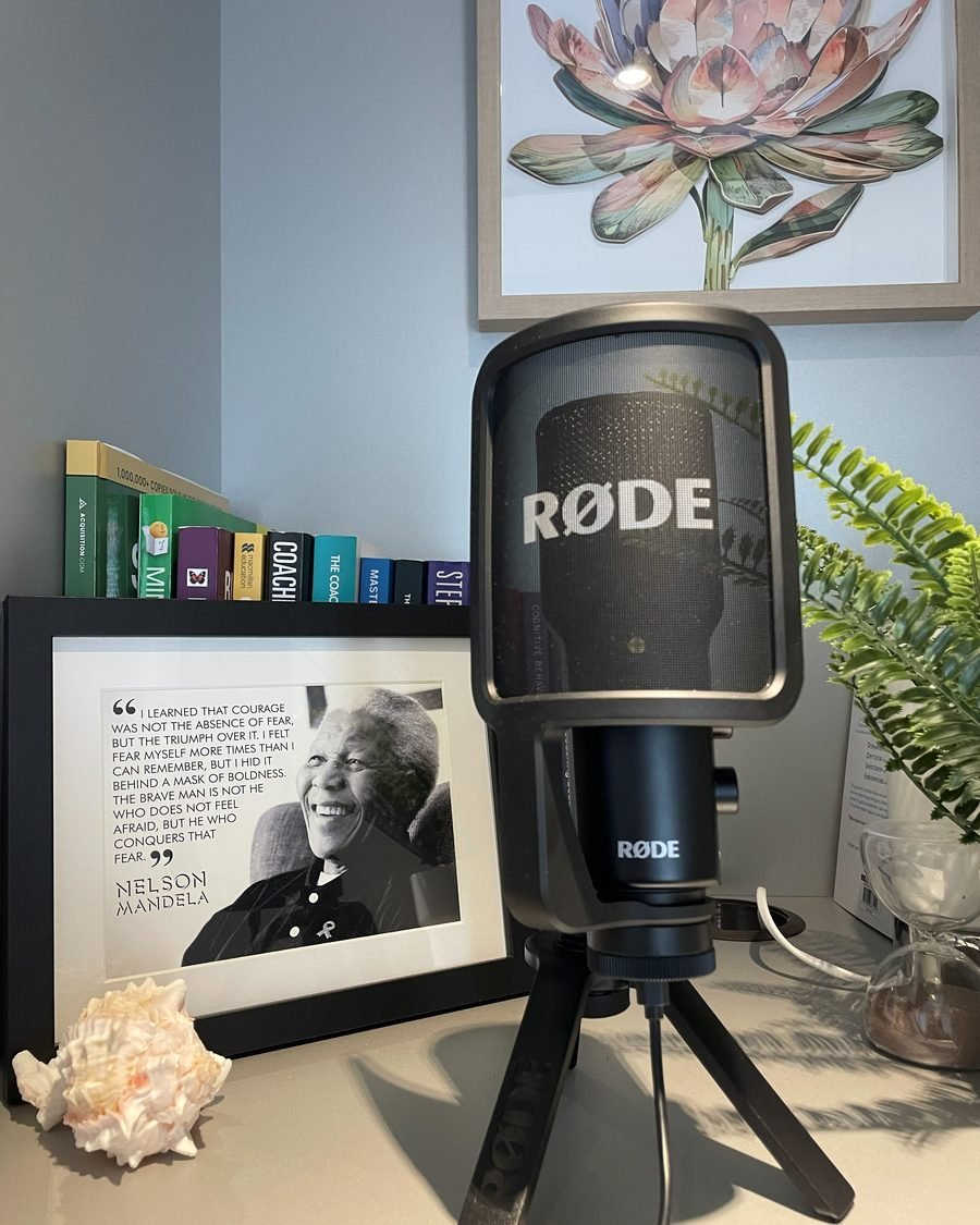 Alicia's microphone on her desk, in front of a framed Nelson Mandela quote